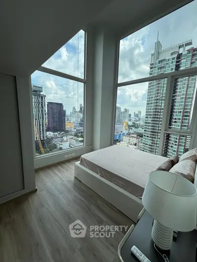 Stunning high-rise bedroom with panoramic city views and modern decor