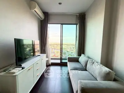 Modern living room with balcony and city view, featuring sleek furniture and natural light.