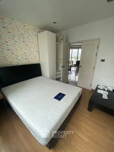 Spacious bedroom with modern decor and large bed in a stylish apartment.