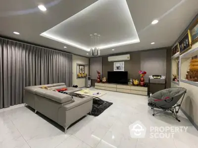 Spacious modern living room with sleek furniture and elegant lighting