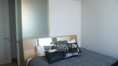 Modern bedroom with stylish decor and cozy bedding in a contemporary apartment.