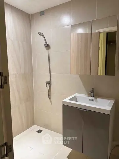 Modern bathroom with sleek shower and vanity in a contemporary apartment.