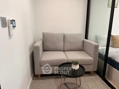 Cozy living area with modern gray sofa and sleek black coffee table