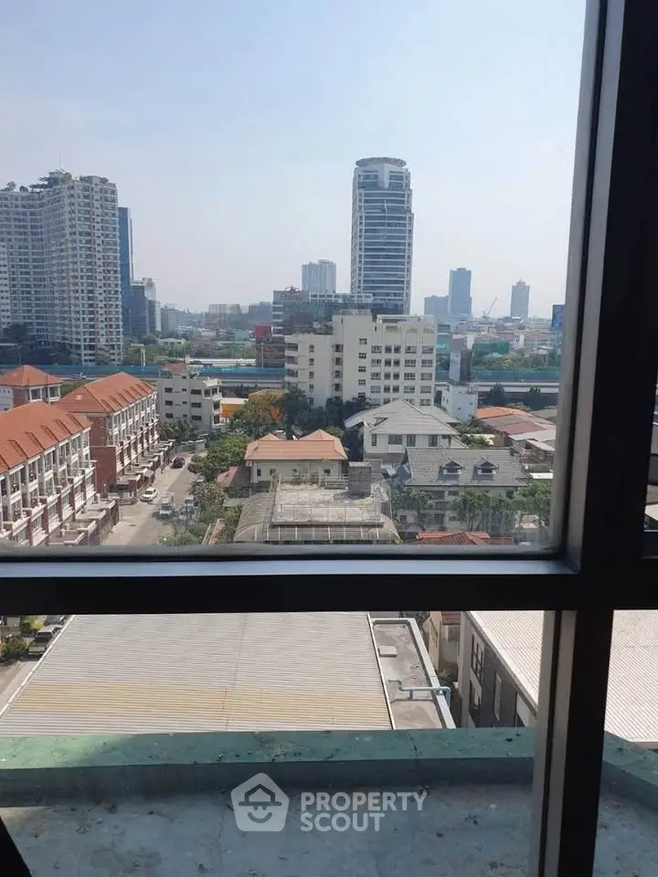 Stunning cityscape view from high-rise window showcasing urban skyline.