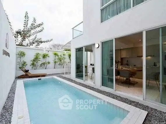 Modern home with sleek pool and open kitchen, perfect for luxury living.
