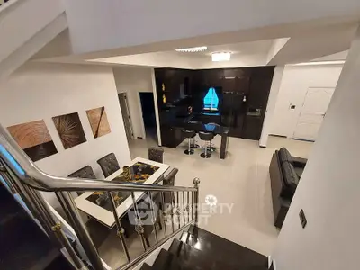 Modern open-plan living room with sleek kitchen and stylish dining area