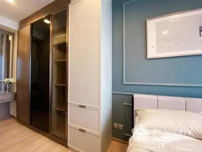 Cozy bedroom with built-in wardrobe and sleek design, featuring a comfortable bed and soft color palette for a tranquil living space.