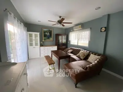 Charming living room with cozy leather sofa and elegant decor, perfect for relaxation and entertaining.