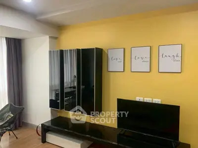 Modern living room with stylish wall decor and sleek black furniture