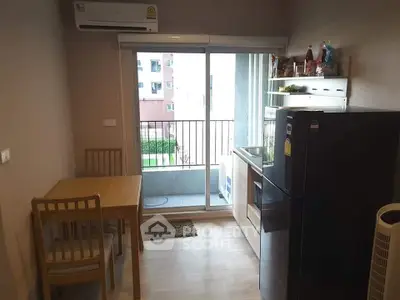 Cozy kitchen with dining area and balcony view in modern apartment