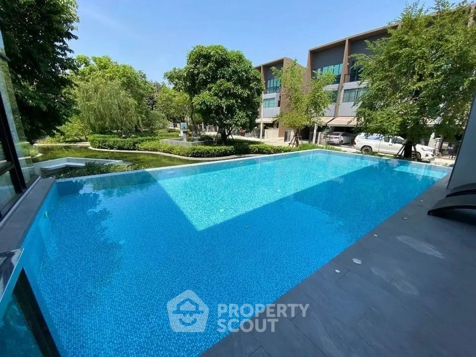 Luxurious residential pool with serene garden view and modern architecture