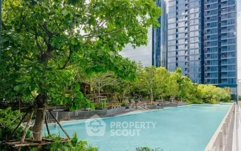Luxurious residential complex with a stunning outdoor pool and lush greenery, perfect for relaxation and leisure.