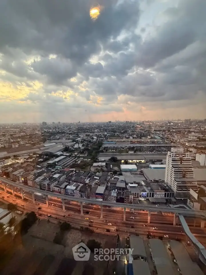 Stunning cityscape view from high-rise building at sunset, showcasing urban skyline and vibrant sky.