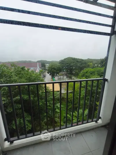 Charming balcony with lush green view, perfect for relaxation and enjoying nature's tranquility.