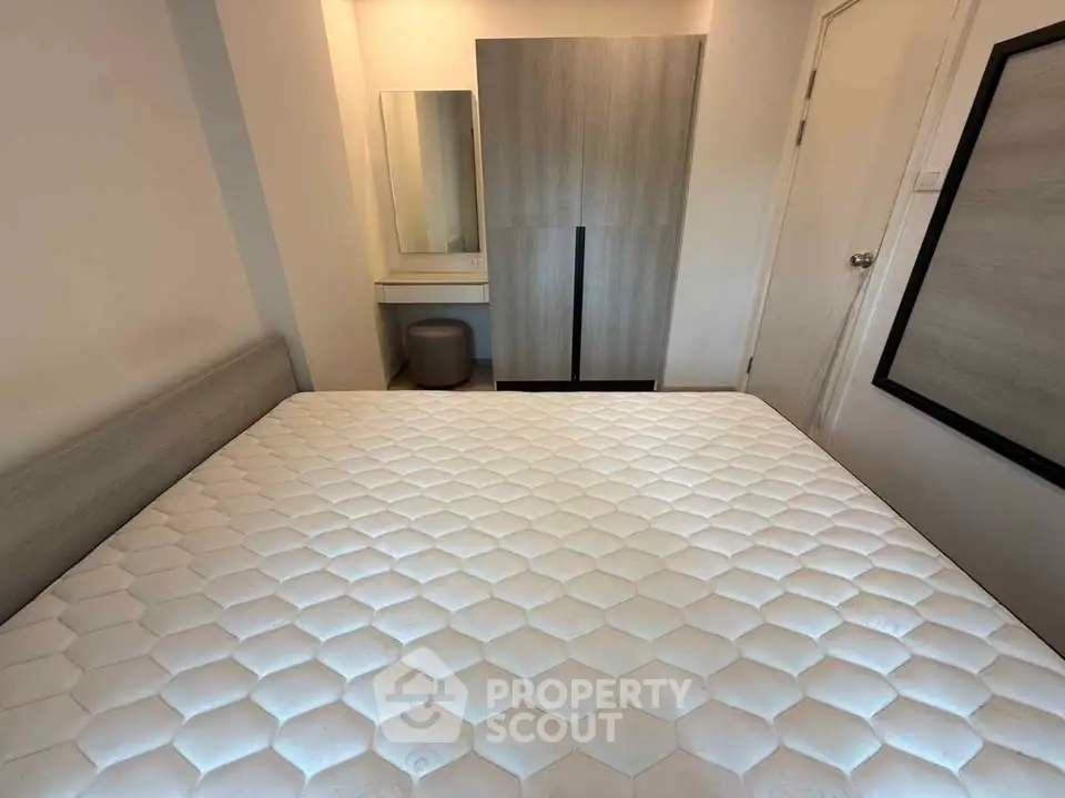 Cozy bedroom with modern furniture and comfortable mattress in a stylish apartment.