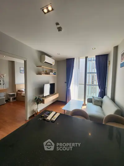 Modern living room with sleek furniture and large windows in a stylish apartment