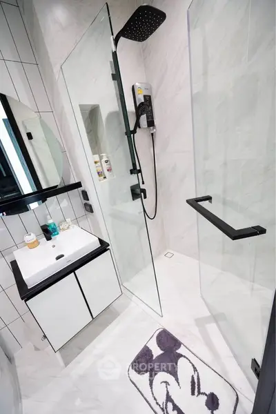 Modern bathroom with sleek shower and stylish vanity in contemporary design.