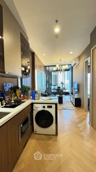 Modern open-layout kitchen with sleek appliances and stylish living room view