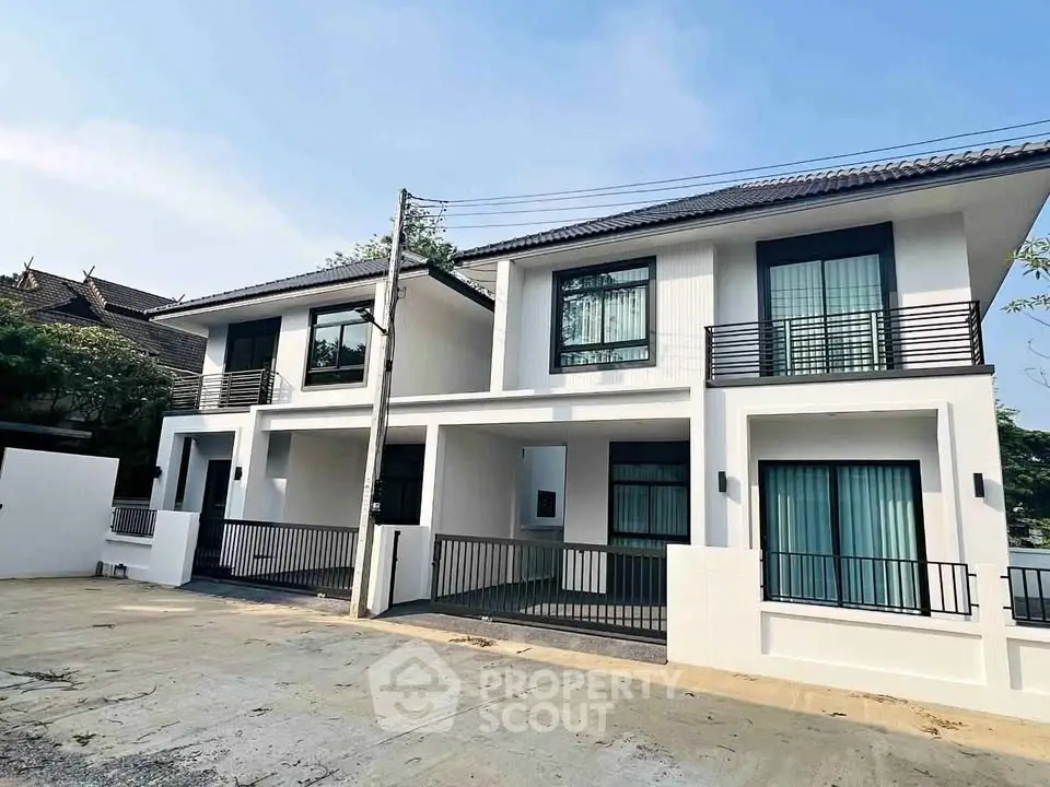 Modern two-story duplex with sleek design and spacious balconies in a serene neighborhood.