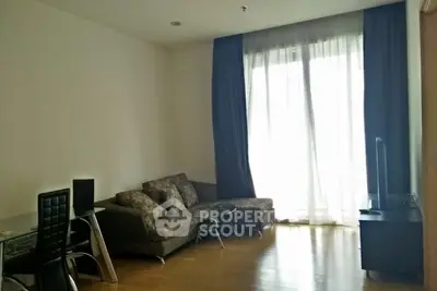 Spacious living room with modern furniture and large window for natural light.
