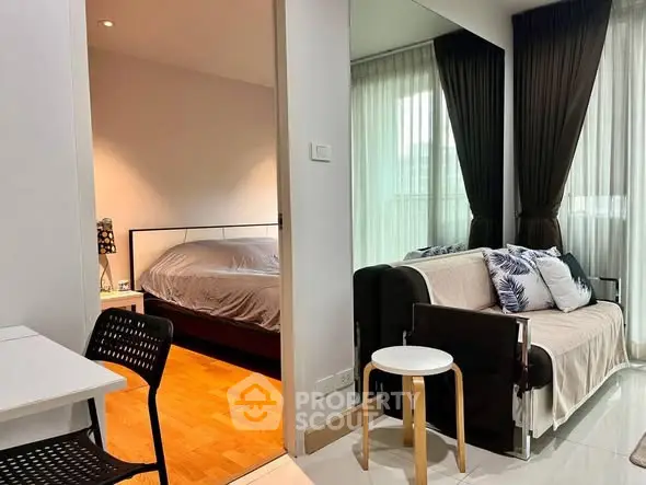 Modern apartment interior with cozy living room and adjacent bedroom