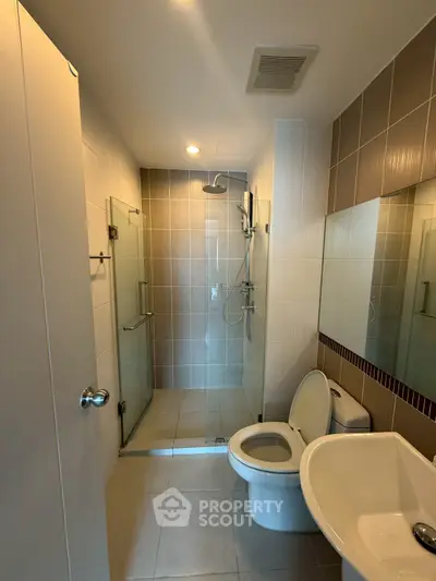 Modern bathroom with glass shower and sleek fixtures