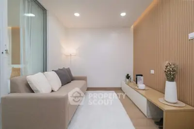 Modern living room with cozy beige sofa, elegant decor, and soft lighting in a stylish apartment.