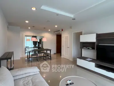 Spacious modern living room with sleek furniture and dining area