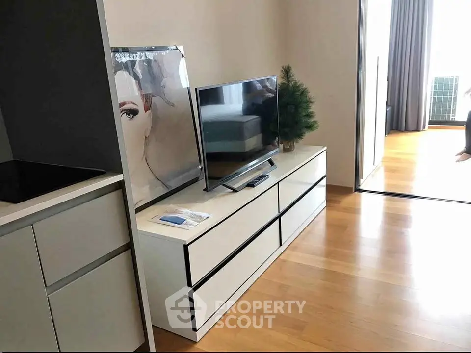 Modern living room with sleek TV stand and stylish decor in a contemporary apartment.