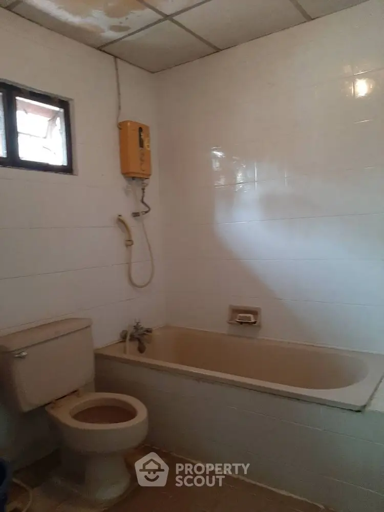 Cozy bathroom with bathtub and shower in a minimalist design