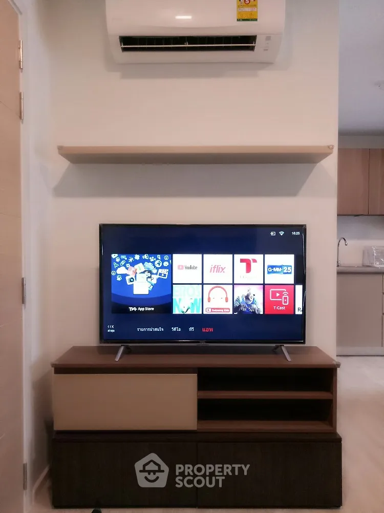 Modern living room with TV and air conditioning unit, sleek furniture design