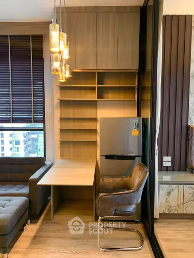 Modern living room with stylish shelving, cozy seating, and elegant lighting in a contemporary apartment.