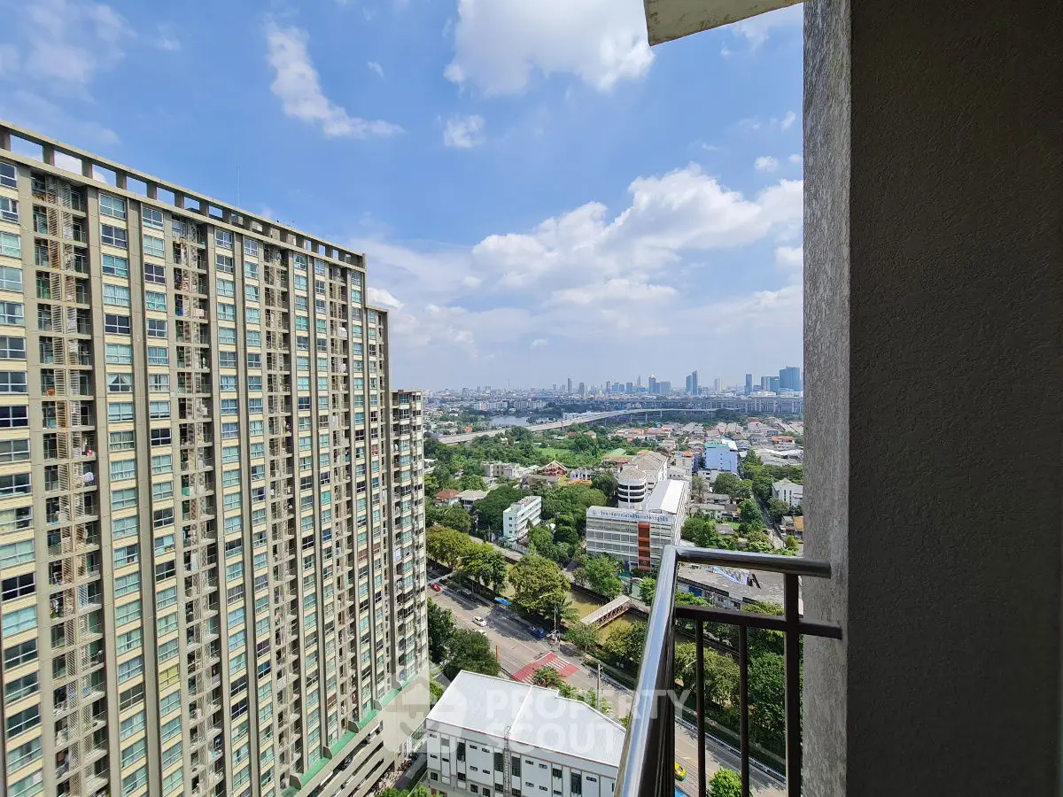 Stunning high-rise balcony view with city skyline and lush greenery