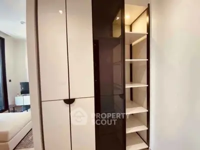 Modern bedroom with sleek built-in wardrobe and cozy bed setup