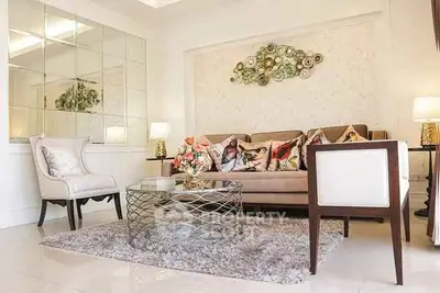 Elegant living room with stylish decor, plush seating, and modern coffee table, perfect for relaxation.
