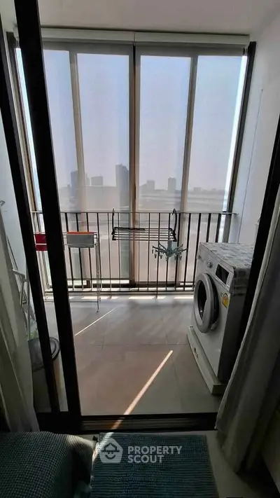 Modern apartment balcony with washing machine and city view