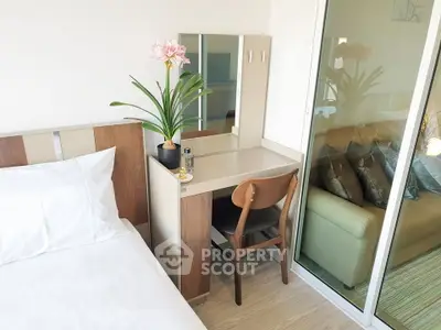 Modern bedroom with sleek design and cozy workspace, featuring a comfortable bed and stylish decor.