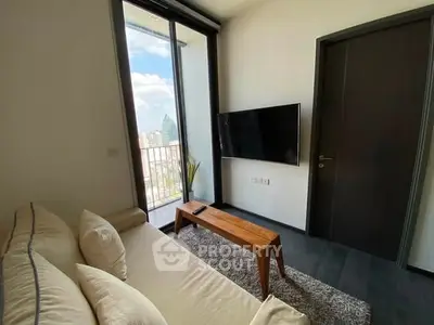 Modern living room with balcony view and sleek decor in urban apartment.