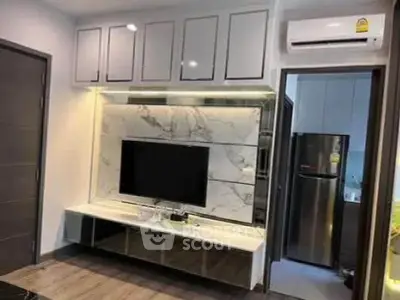 Modern living room with sleek TV unit and open kitchen view
