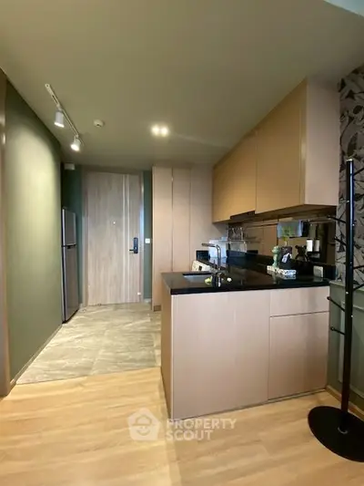 Modern kitchen with sleek cabinetry and open layout in stylish apartment