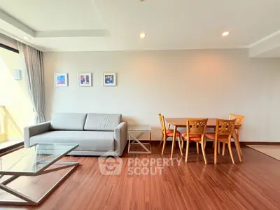 Spacious living room with modern furniture and elegant wooden flooring.