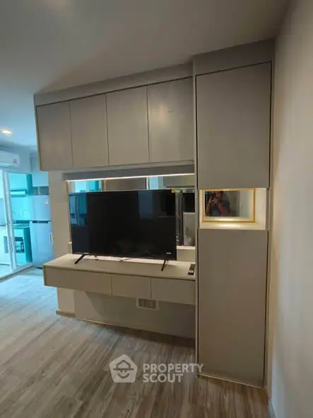 Modern living room with sleek TV unit and open kitchen layout