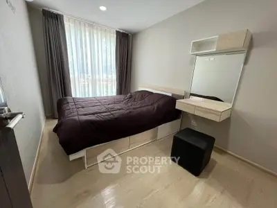 Cozy bedroom with modern furnishings and large window for natural light