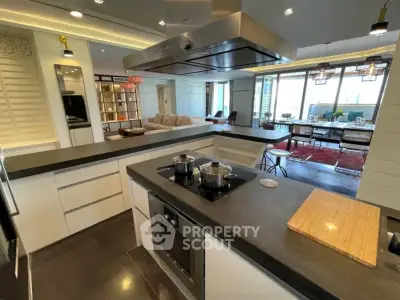 Luxurious open kitchen with modern appliances and spacious living area, perfect for entertaining.