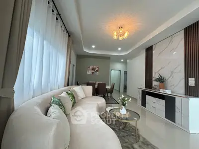 Luxurious modern living room with elegant curved sofa and chic decor