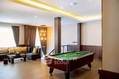 Luxurious living room with pool table and elegant decor