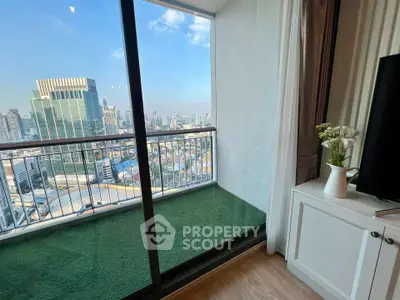 Stunning city view from modern apartment balcony with green flooring and elegant interior decor.