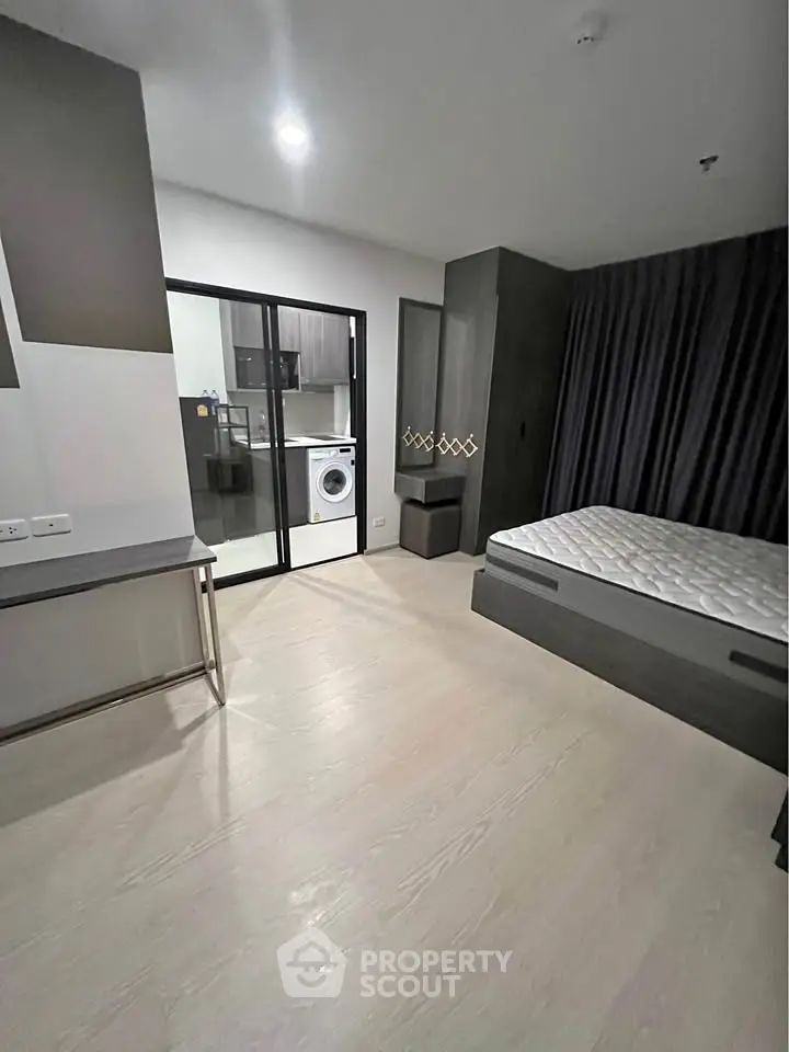 Modern studio apartment with sleek design and in-unit washing machine