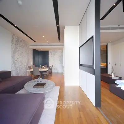Luxurious modern living room with open layout and elegant dining area, featuring sleek furniture and stylish decor.