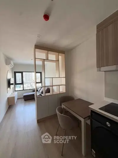 Modern apartment interior with open layout and city view, featuring stylish furniture and natural light.